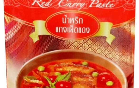 Comparison of eight cooking paste jars including curry, chili, pesto, and miso arranged on a kitchen counter with ingredient labels visible